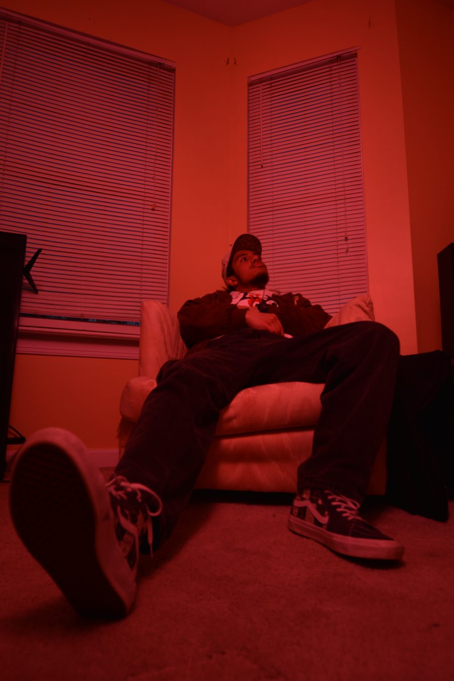 Billere sitting back in a chair with one foot toward the camera